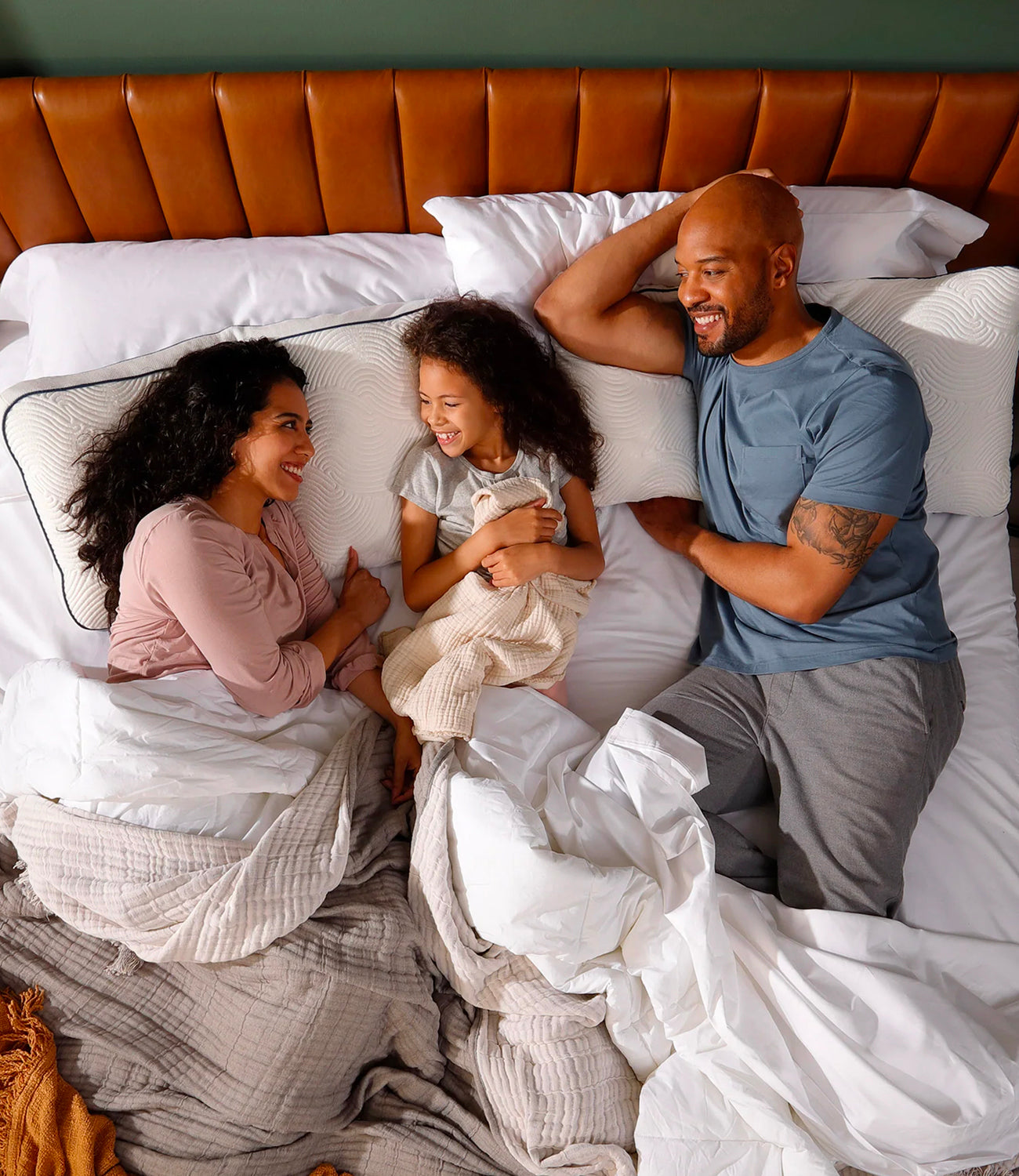 Happy family in modern bedroom relaxing with Parallel Pillows